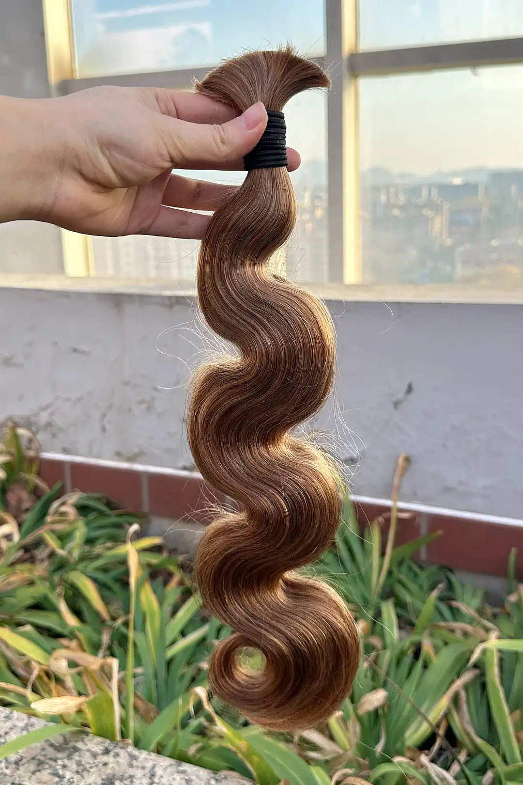 Outdoor picture of light blonde body wave bulk human hair